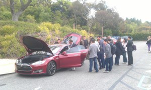 IESE students examining a Tesla Model S
